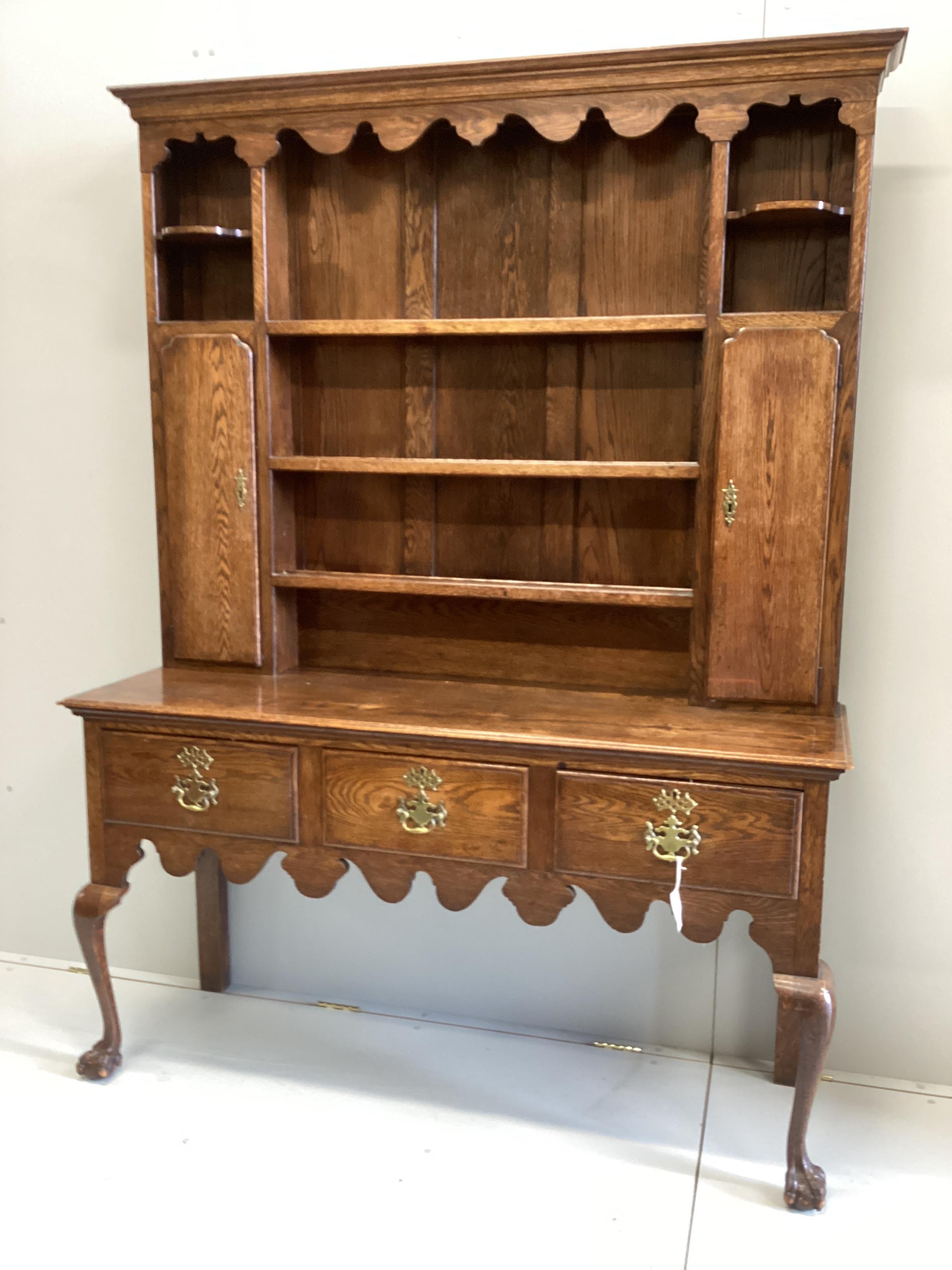 An 18th century style oak dresser with boarded rack width 148cm, depth 50cm, height 206cm.